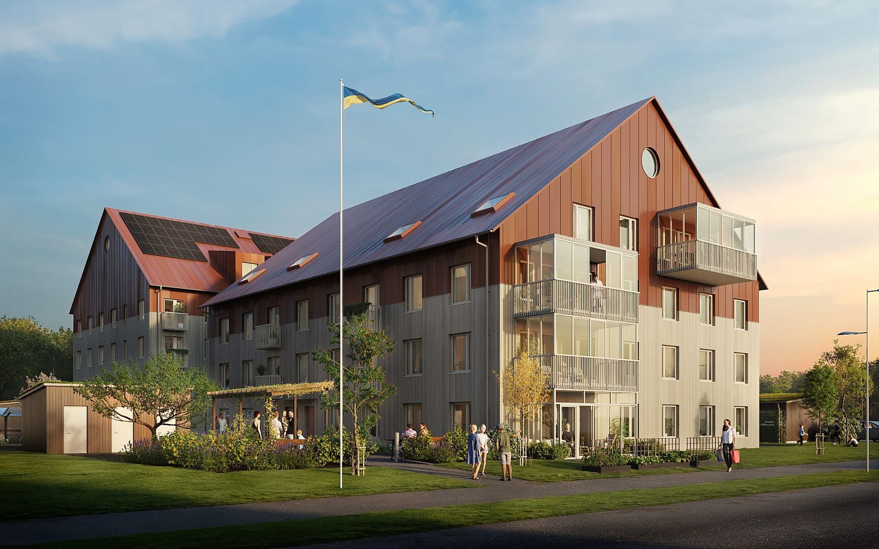 Flerfamiljshus med modern design, solpaneler på taket och svenska flaggan hissad på en flaggstång framför byggnaden